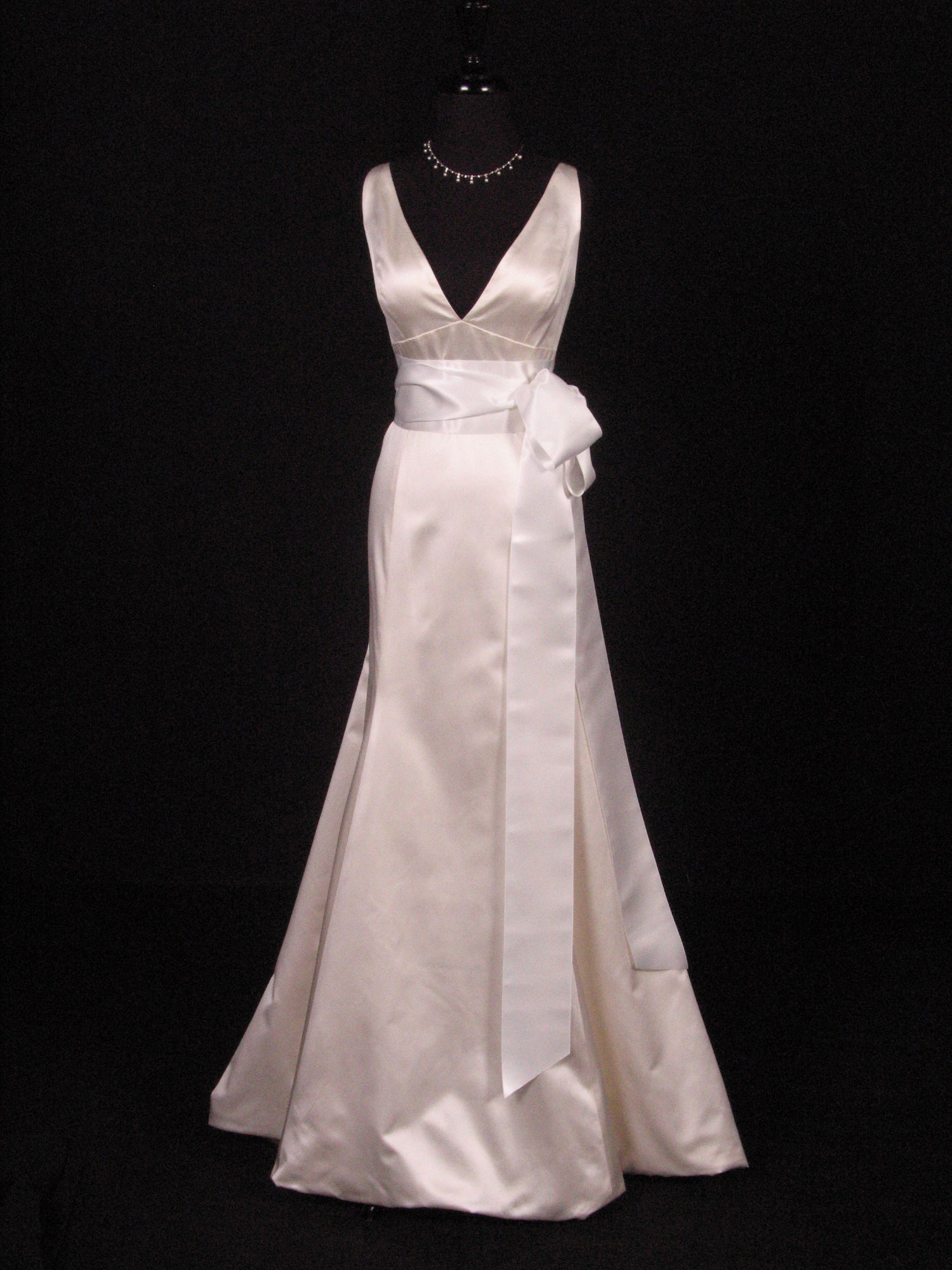 V-neck wedding dress with a bridal white satin sash