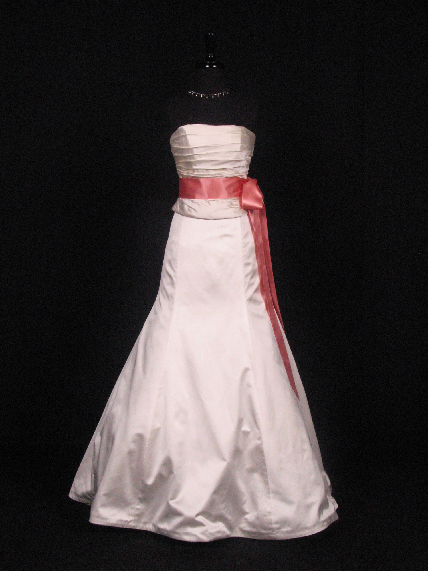 Wedding dress on a form with a tea rose satin ribbon sash