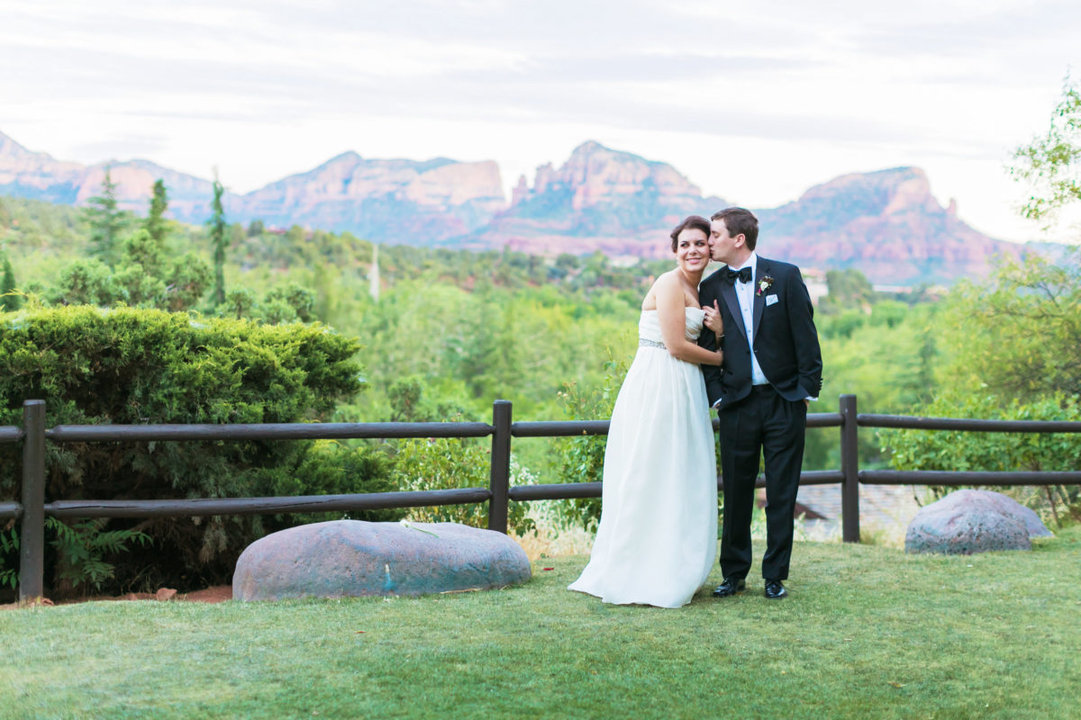 Bride in a Naeem Khan Paris gown with groom before red rock mountains