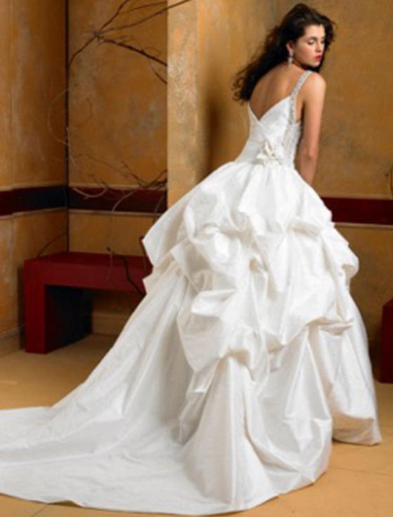 This gorgeous St. Pucchi Yasmine Z207 wedding dress is Brand New! The breathtaking Yasmine sleeveless wedding dress is made from beautiful ivory silk shantung fabric and has a pick-up style ball gown wedding dress skirt with a drop waist. The straps and sides of the bodice are embellished with gorgeous beading. This gown is very easy to dance in and wear for hours and hours. You will look amazing as you walk down the aisle in this stunning couture wedding dress! #ballgownweddingdresses #yourdreamdress #bridalsale